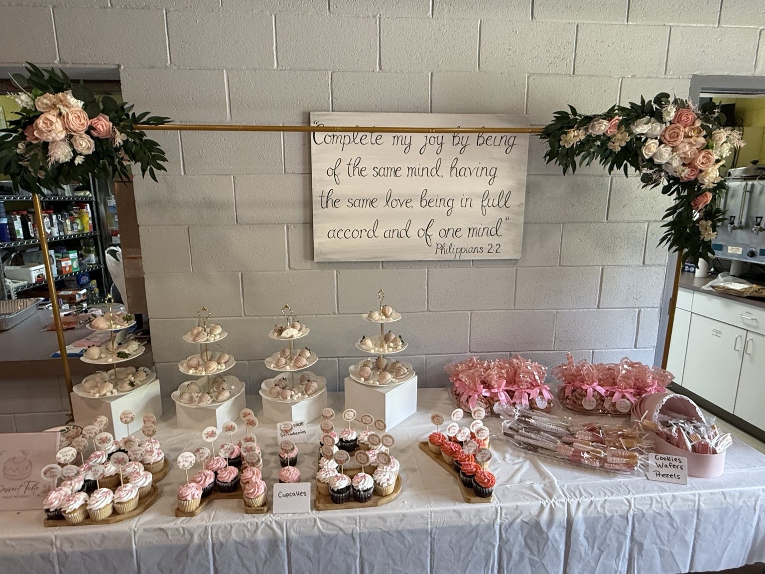 Elegant dessert table display with blush and white treats